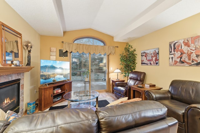 living room with a tile fireplace and lofted ceiling