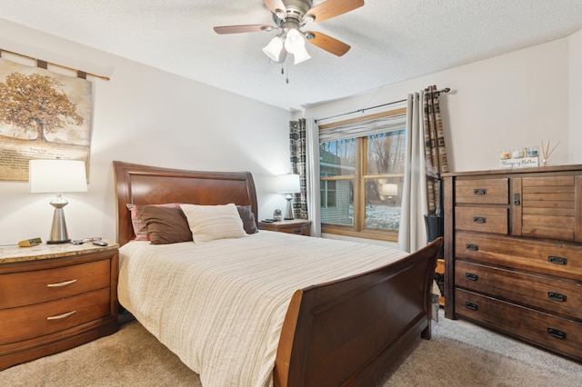 carpeted bedroom with ceiling fan and a textured ceiling