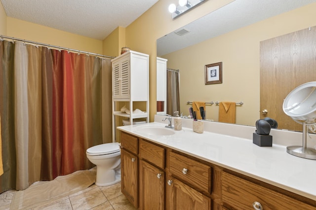 bathroom with vanity, a textured ceiling, tile patterned floors, and toilet