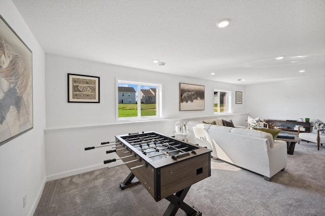 playroom featuring a textured ceiling and carpet floors