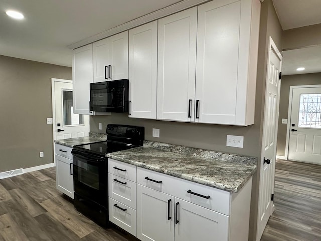 912 Oakley St, Luverne, MN 56156 - kitchen with dark hardwood / wood-style floors, white cabinets, light stone counters, and black appliances