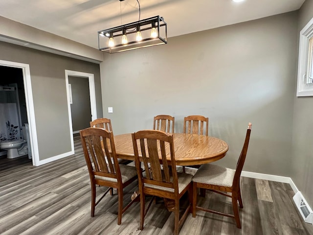 912 Oakley St, Luverne, MN 56156 - dining space featuring dark wood-type flooring and an inviting chandelier