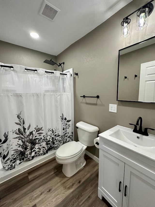 912 Oakley St, Luverne, MN 56156 - bathroom featuring vanity, wood-type flooring, toilet, and walk in shower