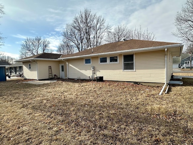 912 Oakley St, Luverne, MN 56156 - rear view of house featuring a patio, a yard, and central air condition unit