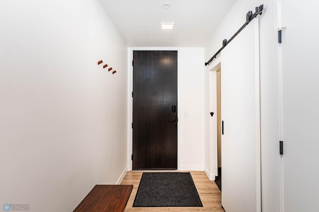 entryway featuring a barn door and light wood-type flooring