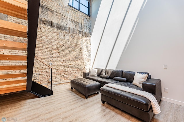 living room with hardwood / wood-style flooring and a towering ceiling