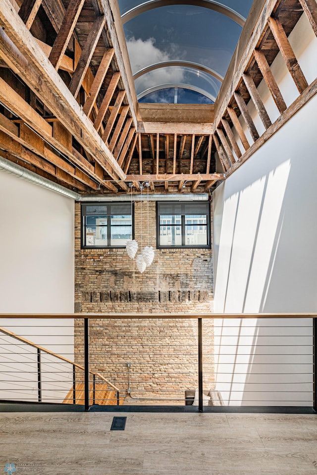 stairway featuring wood-type flooring and a towering ceiling