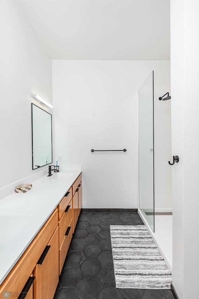 bathroom with walk in shower and vanity