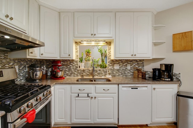 kitchen featuring white dishwasher, sink, stainless steel gas stove, white cabinetry, and extractor fan