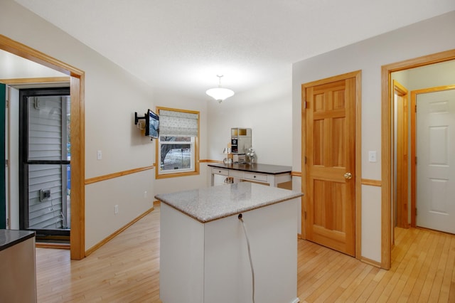 kitchen featuring light wood-type flooring and white cabinetry