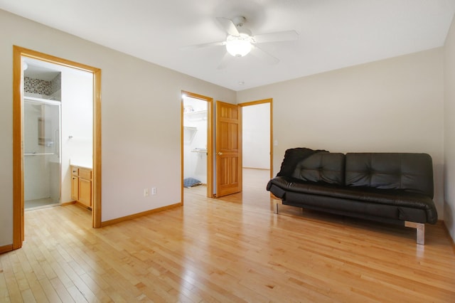 living area with ceiling fan and light wood-type flooring