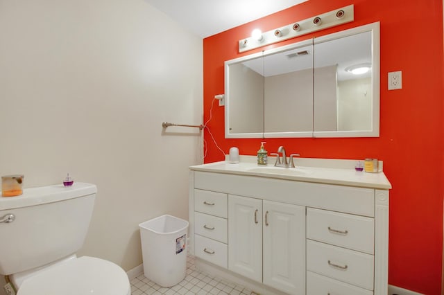 bathroom featuring tile patterned floors, vanity, and toilet