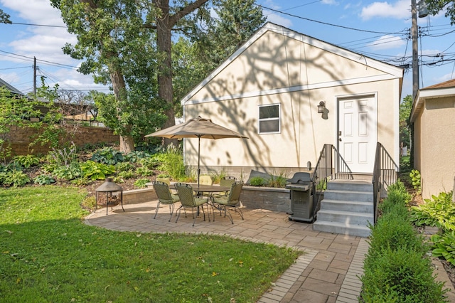 back of property featuring a patio and a yard