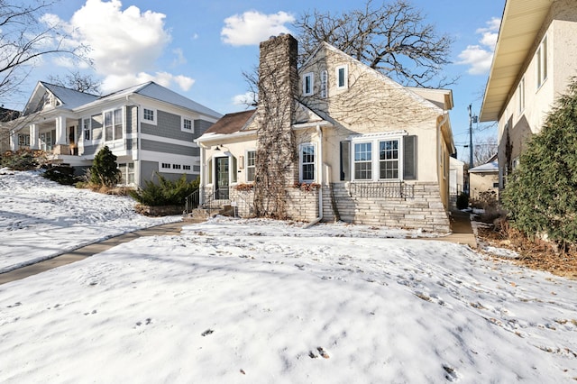 snow covered property with a garage