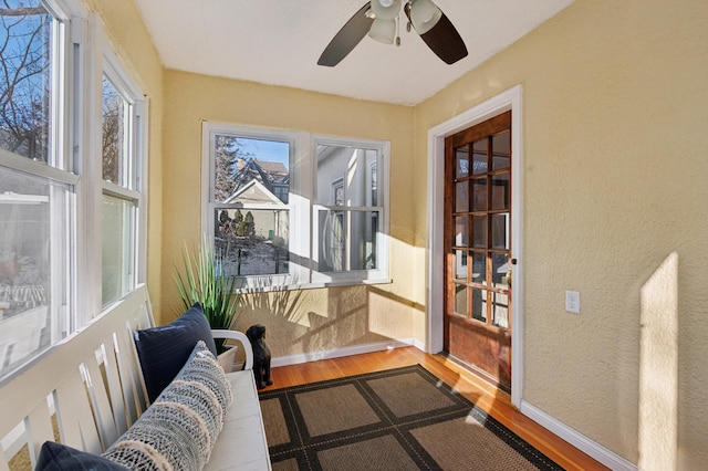 sunroom featuring ceiling fan