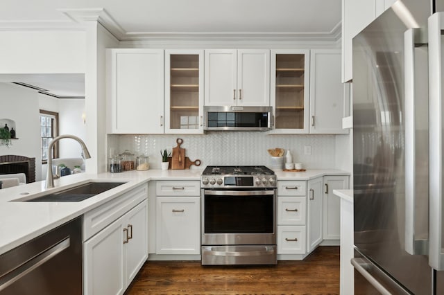 kitchen with sink, stainless steel appliances, tasteful backsplash, white cabinets, and dark hardwood / wood-style flooring