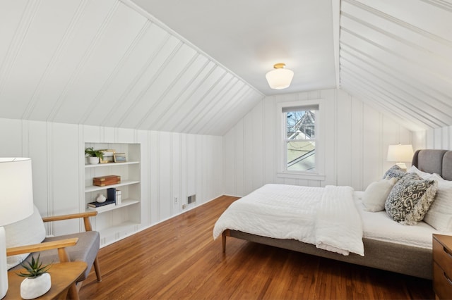 bedroom with wood-type flooring and vaulted ceiling