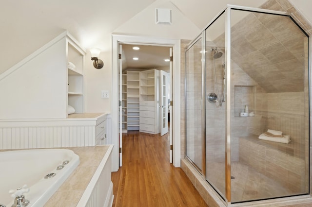 bathroom with lofted ceiling, wood-type flooring, and shower with separate bathtub