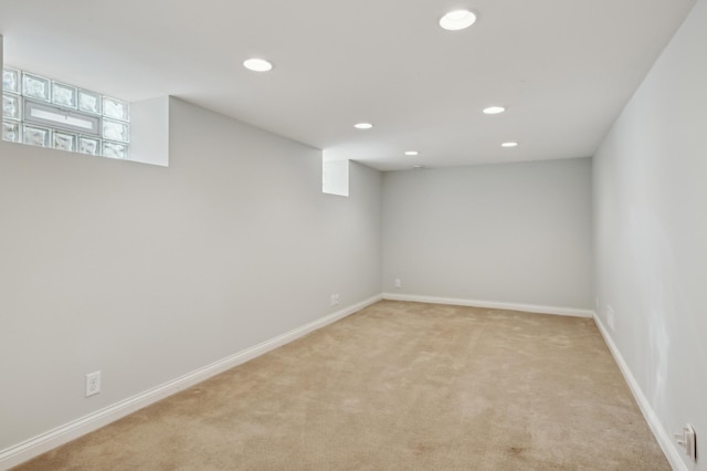 basement featuring light colored carpet