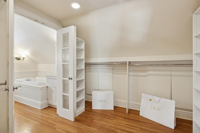 spacious closet with wood-type flooring and lofted ceiling