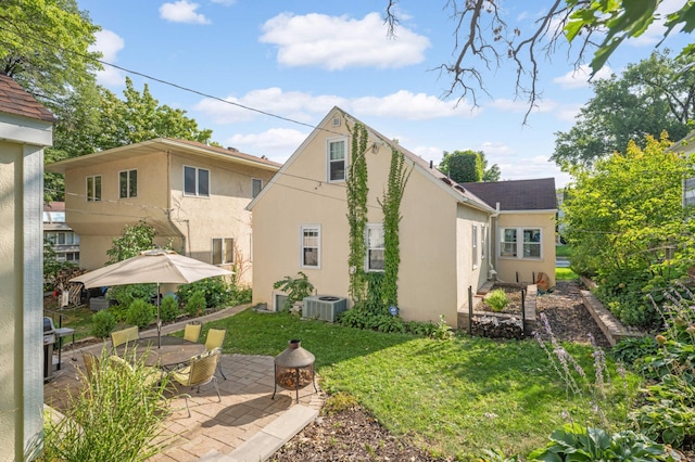 back of property featuring central AC, a yard, and a patio