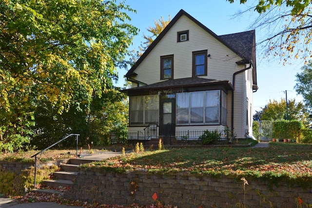 view of front of home with a sunroom