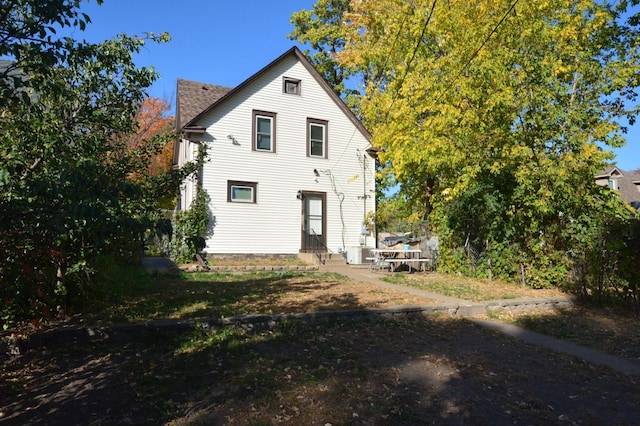 rear view of house with central air condition unit