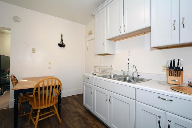 kitchen with white cabinetry, sink, and dark wood-type flooring