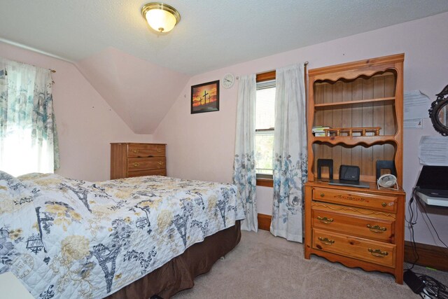 bedroom with light carpet and vaulted ceiling