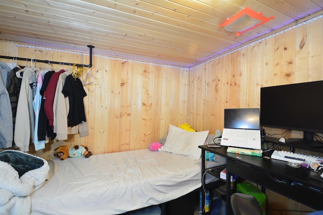 bedroom with wooden ceiling and wood walls