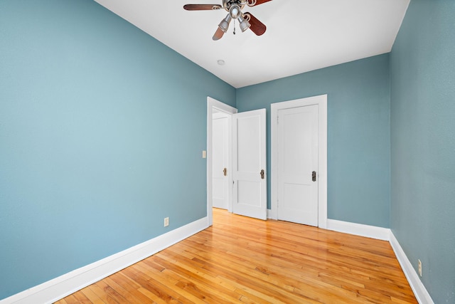 unfurnished bedroom with ceiling fan and light hardwood / wood-style floors