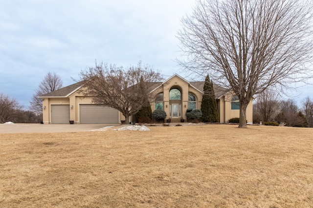 view of front of house featuring a garage and a front lawn