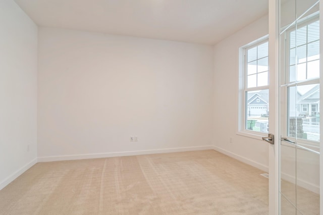 empty room featuring light colored carpet