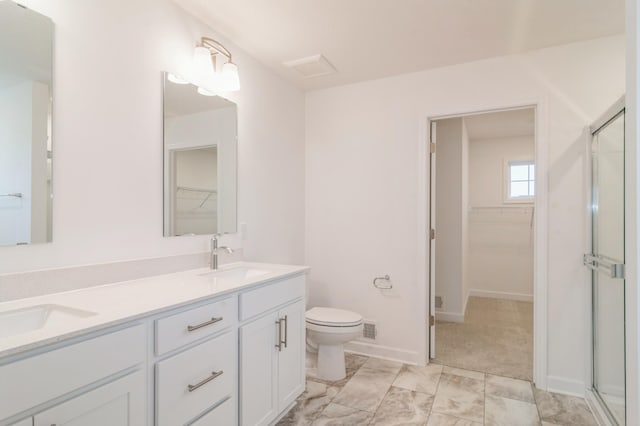 bathroom with toilet, vanity, and walk in shower