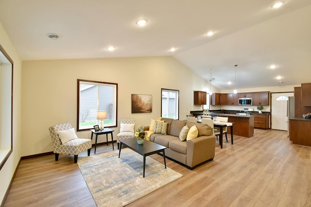 living room featuring light hardwood / wood-style flooring and lofted ceiling