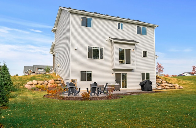 back of property with a yard and a patio