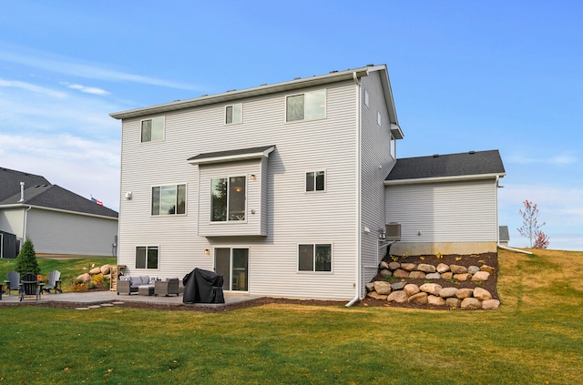 rear view of property with cooling unit, an outdoor hangout area, a yard, and a patio area