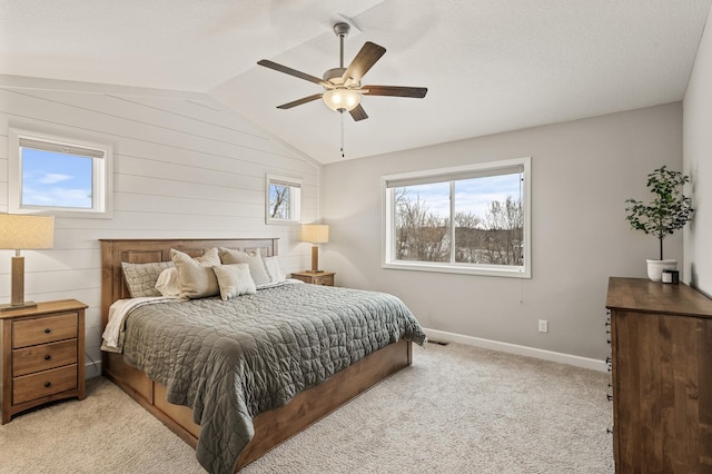 bedroom with ceiling fan, lofted ceiling, and light carpet