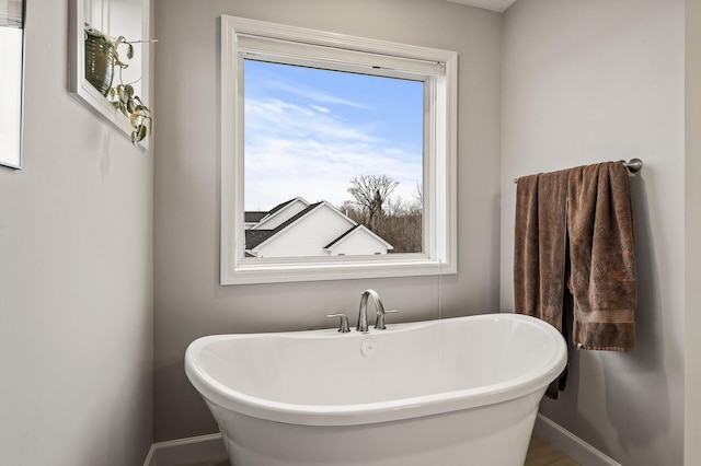 bathroom with wood-type flooring and a bathing tub