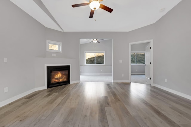 unfurnished living room with ceiling fan, light hardwood / wood-style floors, and vaulted ceiling