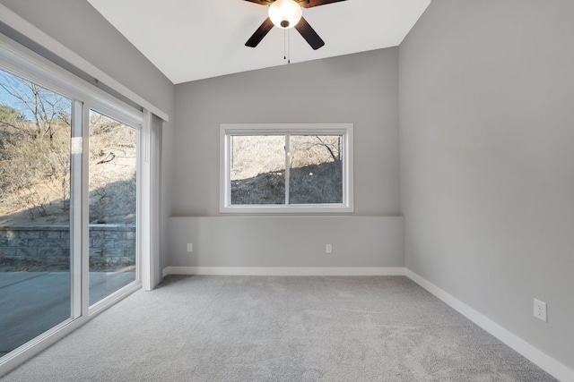 spare room with light colored carpet, vaulted ceiling, and ceiling fan