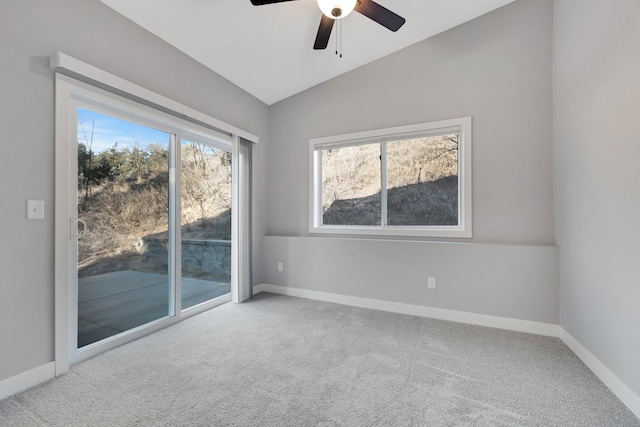 carpeted empty room featuring ceiling fan and lofted ceiling