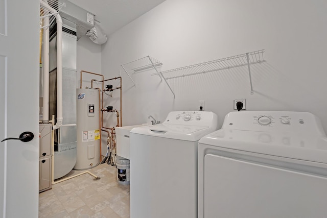 washroom featuring washer and clothes dryer and water heater