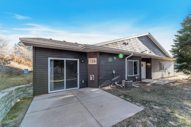 back of property with cooling unit and a patio