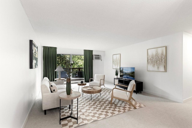 living room with a textured ceiling, light carpet, and a wall mounted AC