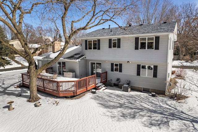 exterior space with central AC unit, a chimney, and a wooden deck