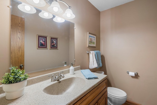 bathroom with toilet and vanity