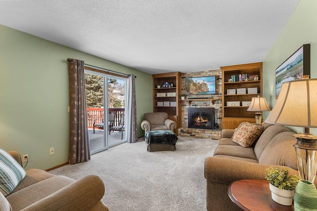 carpeted living room with built in features, baseboards, a textured ceiling, and a brick fireplace