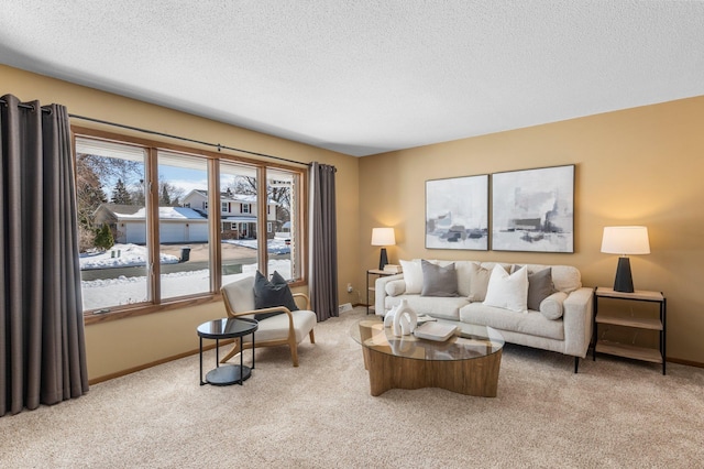 living room featuring a textured ceiling, baseboards, and carpet floors