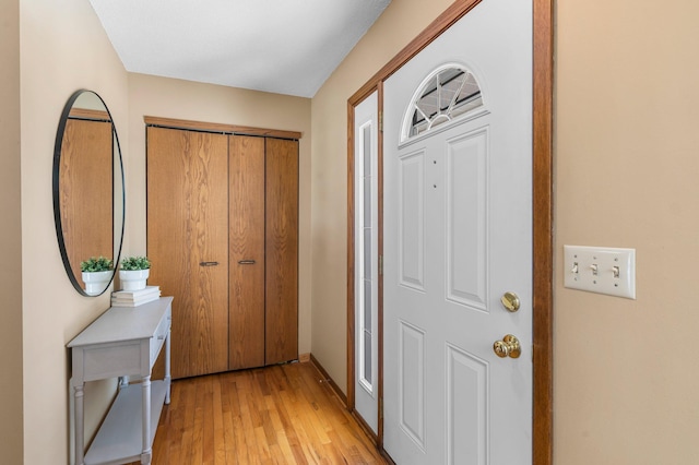 entrance foyer featuring baseboards and light wood-style floors